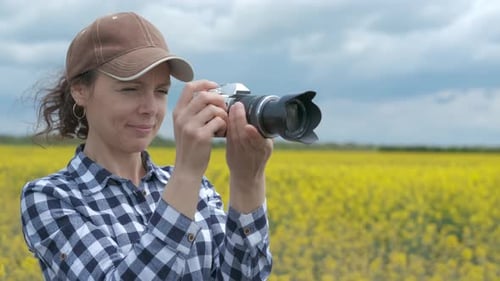 Woman takes photo in the field.