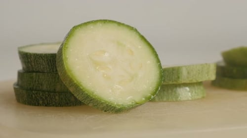 Organic zucchini slices on pile 4K 2160p 30fps UltraHD tilting footage - Close-up of Pepo cylindric
