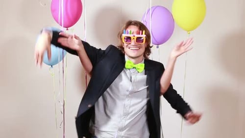 Cheerful couple dancing funny in photo booth