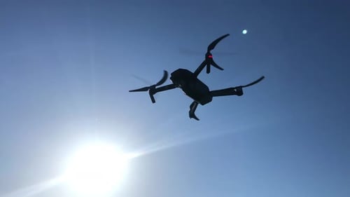 Drone Flying Against Blue Sky