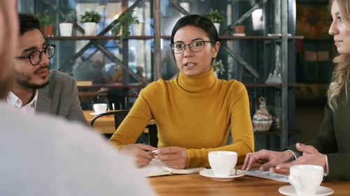 Multiracial Professionals Discussing Business in Restaurant