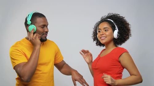Man and Woman Dancing Together Wearing Headphones