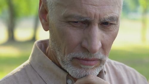 Lonely Old Man Sitting in Park and Bitterly Crying, Closing Face With Hands