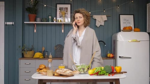 Woman Talking on Phone in Kitchen