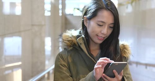 Young Woman Typing on Smartphone Indoors
