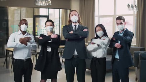 Office Team Stands and Looks at the Camera Managers in Protective Medical Masks Working