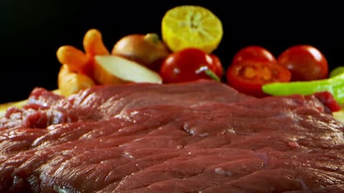 Raw Steak and Fresh Ingredients on Cutting Board