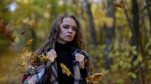 Leaf Fall in Autumn Woman is Walking Alone in Park and Leaves are Falling on Her