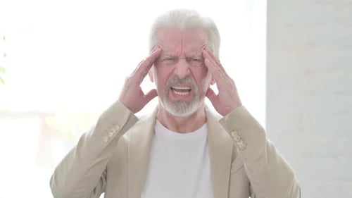 Senior Man Suffering From a Terrible Headache