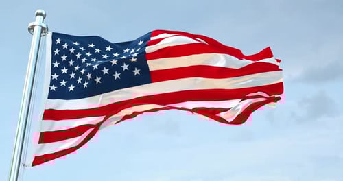 Realistic American Flag Waving on a Pole Against Blue Sky