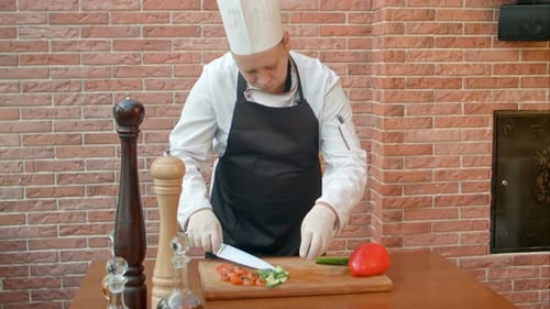Chef Slicing Fresh Green Cucumbers
