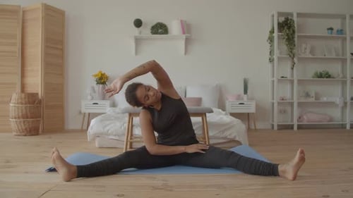 Woman Doing Yoga Stretch At Home