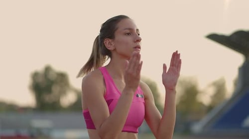 Female Athlete Warming Up Before a Track Race