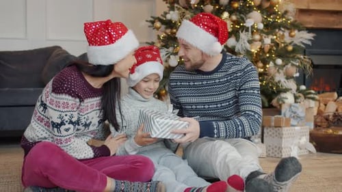 Family Opening Gifts on Christmas Morning