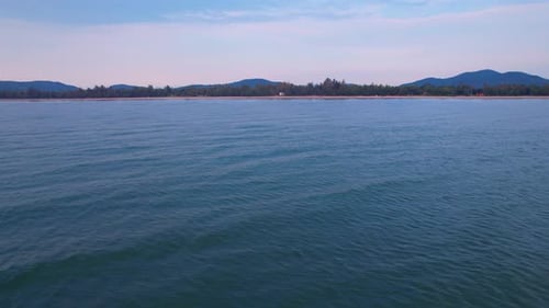 4K Aerial view of drone move on beautiful sea. sunset over ocean waves sand beach.