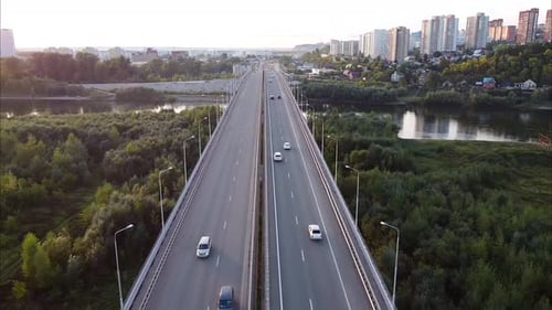 View of Cars Driving on the Road Highway Bridge Aerial Highaltitude Flight of a Drone
