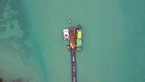 Aerial view from a drone of a commercial ship moored in the marina.