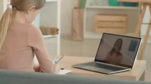 Girl Learning Online at Home with Laptop