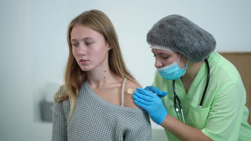 Happy Teenage Girl Gesturing Thumb Up Getting Covid19 Vaccine Shot Looking at Camera Smiling