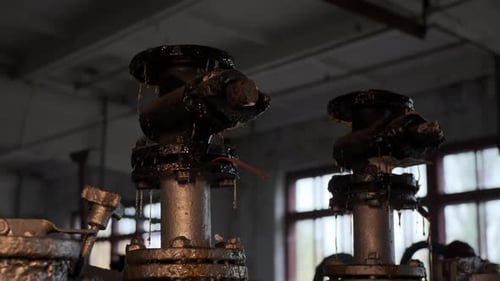 Flanged Old Rusty Dirty in Oil or Dried Paint Faucet or Valve on Pipe Sun Warm Yellow Light Shines