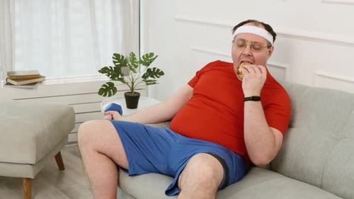 Man Doing Curls While Eating a Sandwich