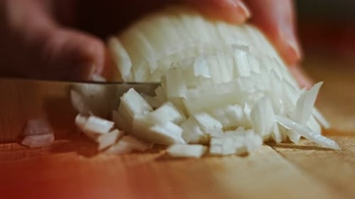 Dicing Onion on Wooden Cutting Board Close Up