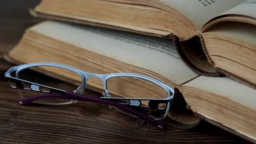 Old Books and Glasses on Wooden Surface