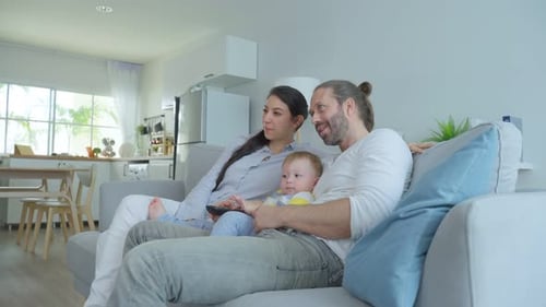 Family Relaxing Together on Couch Watching Television