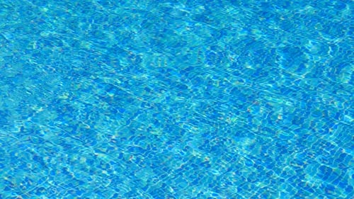 Abstraktes Poolwasser kristallklar mit reflektiertem Sonnenlicht