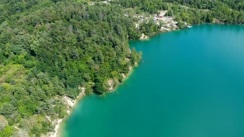 Aerial View of a Blue Lake Surrounded By Forest