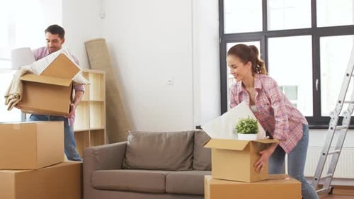 Happy Couple with Stuff Moving To New Home