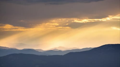 Scenic Mountain Range Illuminated by Golden Sunset