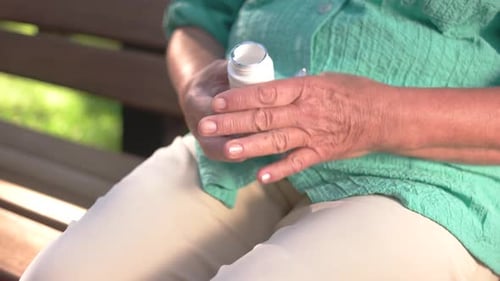 Elderly Person Opens Prescription Medicine Bottle