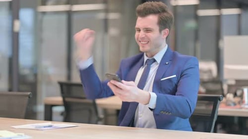Excited Young Adult Celebrating Good News on Phone