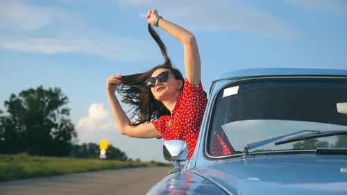 Woman Enjoys Road Trip in Classic Car