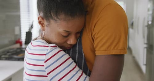 Affectionate Couple Embracing in Kitchen