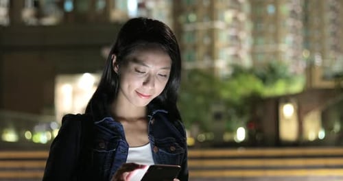 Woman Using Mobile Phone at Night, Urban Scene