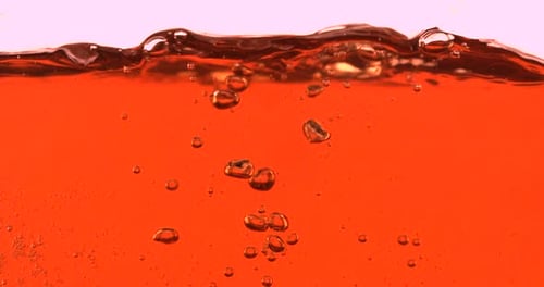 Ice Cube Splash in Orange Liquid