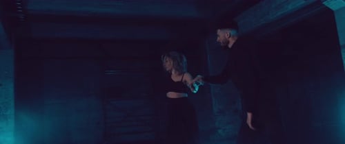 Dancing Duo Illuminated by Neon Lights at Night