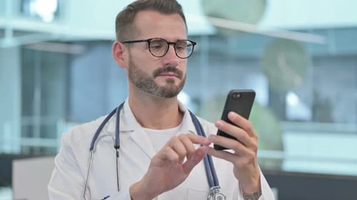 Doctor Using Smartphone in Modern Hospital Setting