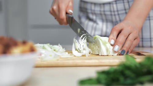 Closeup Female Housewife Hands Cutting Half Slice Cabbage on Wooden Board