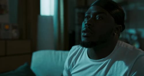 Young Adult Man Reacts to Something Shocking on TV
