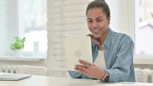 Young Woman Video Calling with Tablet Indoors
