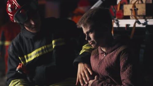 Rescuers Supporting Teen Survivor at Night