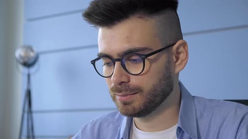 Young Man Working at Computer Close Up