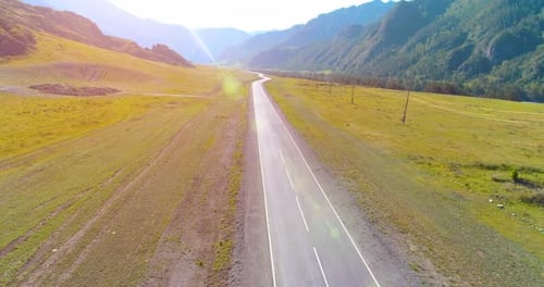 Flight Over Mountain Asphalt Highway Road and Meadow