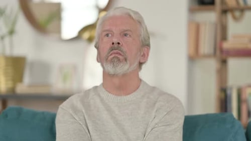 Senior Man Sitting and Looking Around