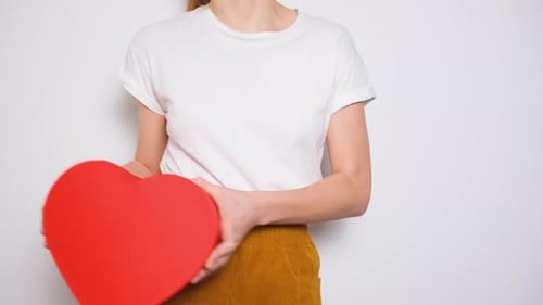 Young Woman Holds Heart Shaped Gift Box
