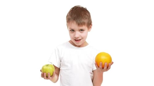 Boy Holds Apple and Orange, Healthy Choice