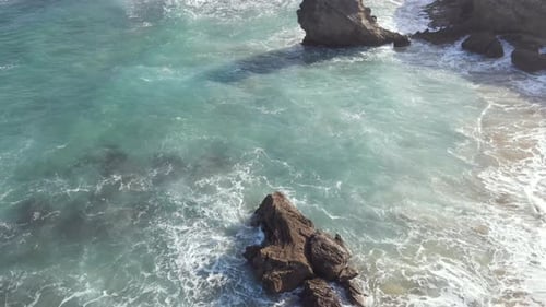 Drone Flying Over Beach with Rocky Shoreline